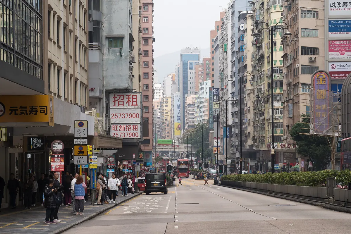 Nathan Road in Hong Kong by day, with shop signs and traffic
