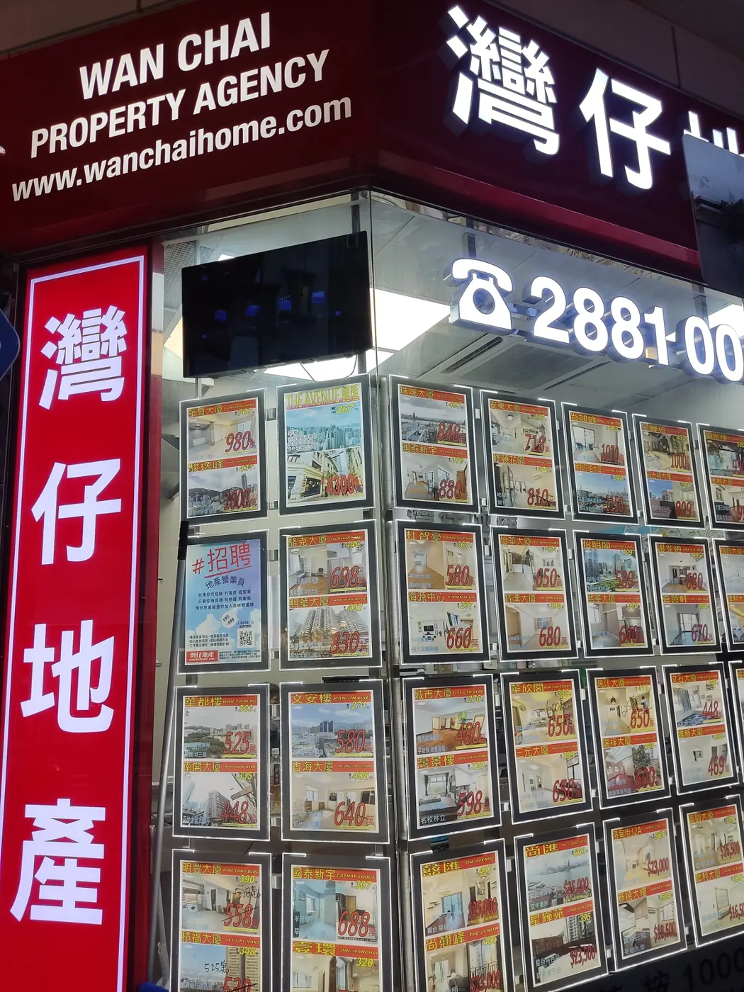 Property listings in Chinese pasted in an agency window in Wan Chai